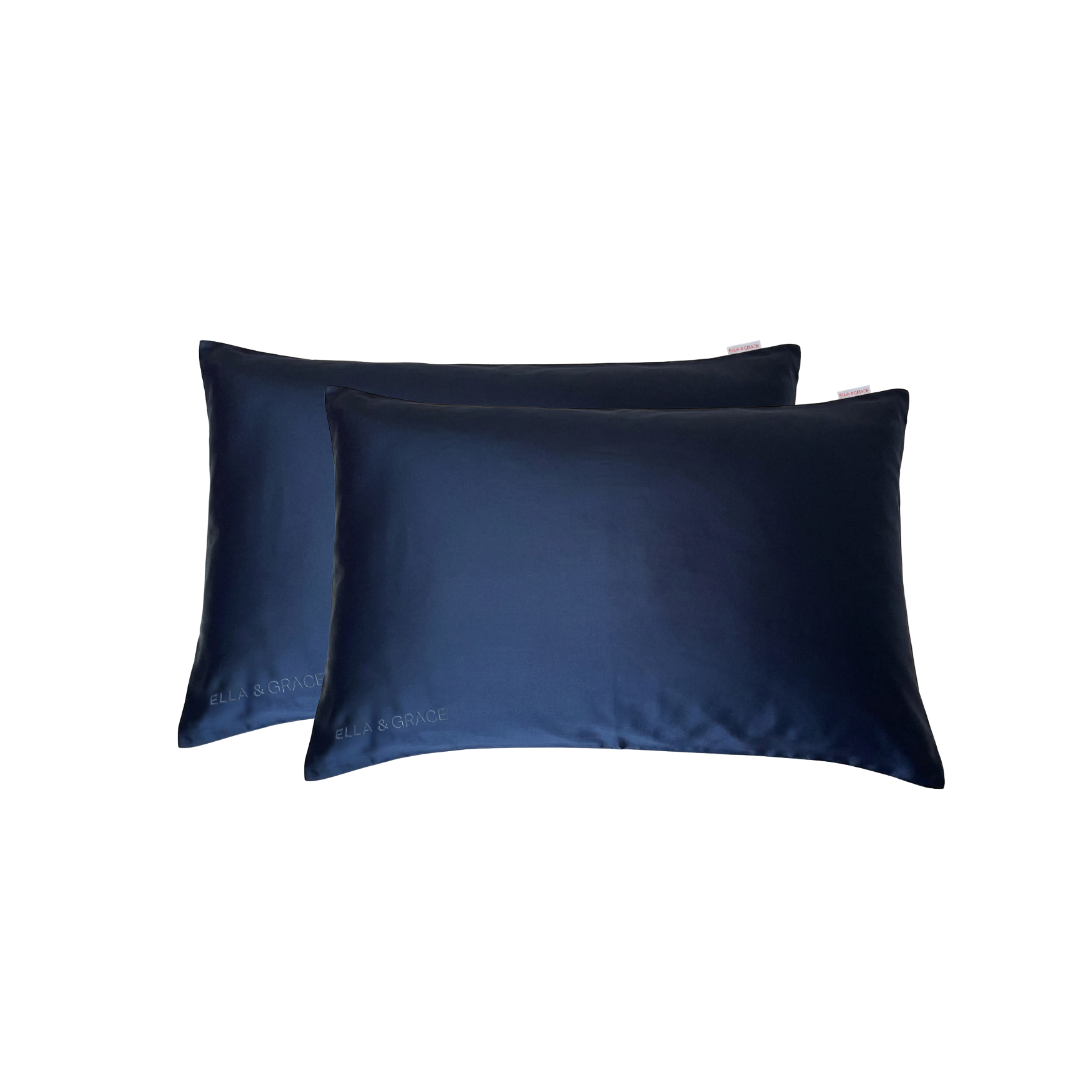 Two navy blue silk pillowcases stacked together on a plain white background with ELLA & GRACE Brand.